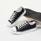 Men's canvas low-top sports shoes, featuring a classic casual design. This stylish pair comes in white and black colors and is suitable for daily wear.