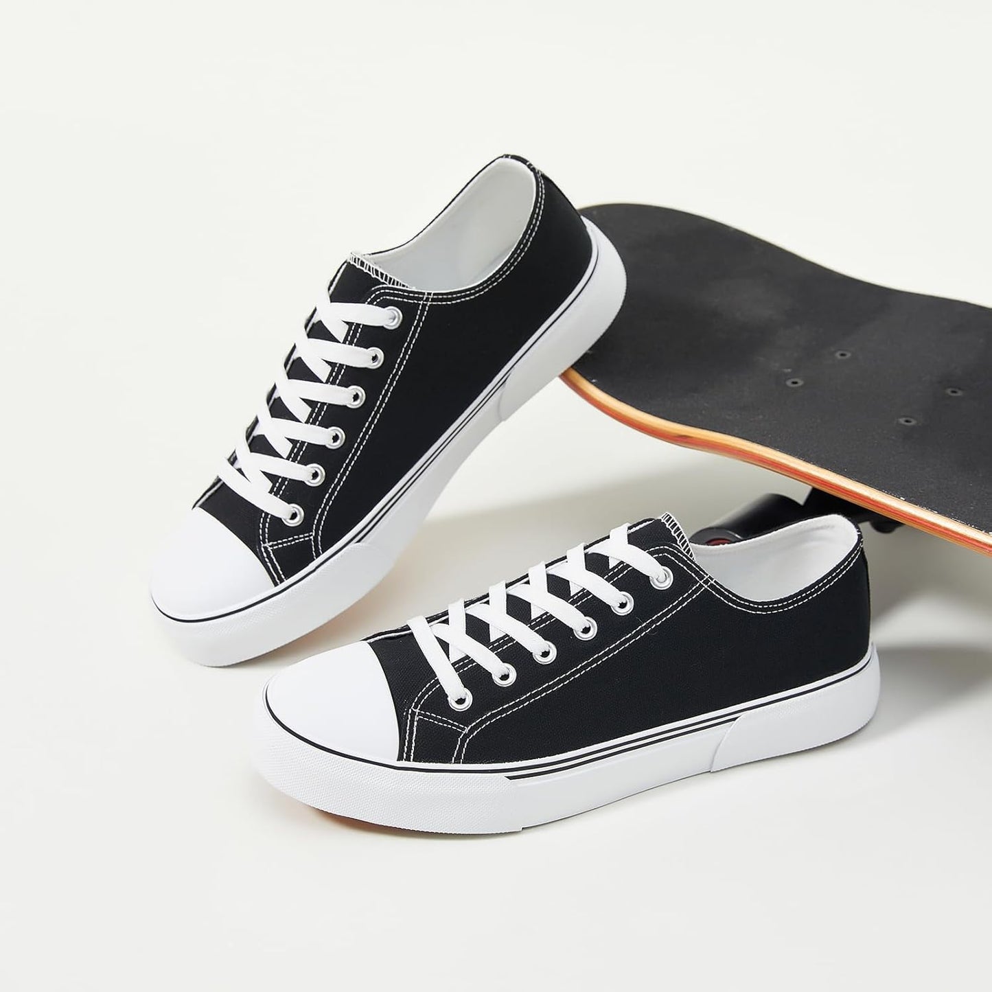 Men's canvas low-top sports shoes, featuring a classic casual design. This stylish pair comes in white and black colors and is suitable for daily wear.